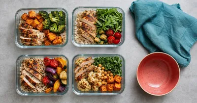 The Best Meal Planning Apps (And Why Most Biohackers Outgrow Them) Flat lay of four prepped meal containers with chicken, grains and vegetables