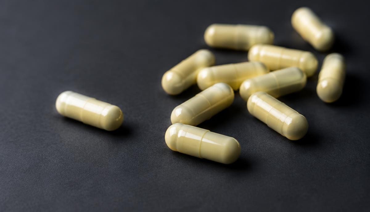 DoseRoutine Alpha-Lipoic Acid Pale yellow capsules in a glass dish on a matte surface